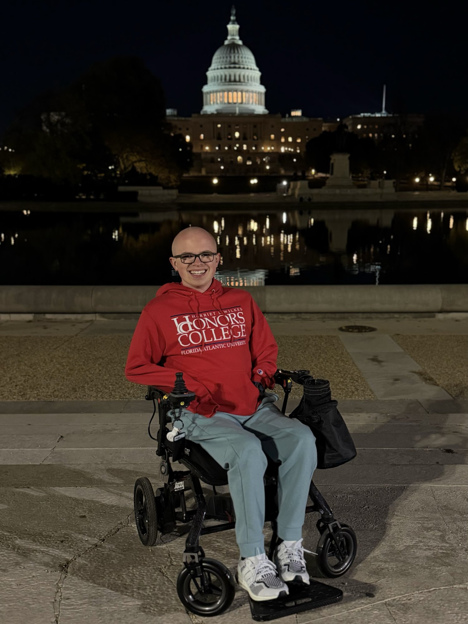 A power wheelchair joystick snapped and taped back together after air travel damage.